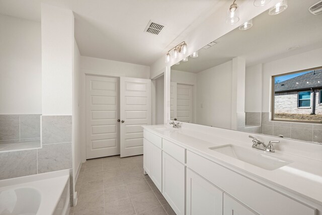 full bathroom featuring tile patterned floors, toilet, vanity, and tiled shower / bath