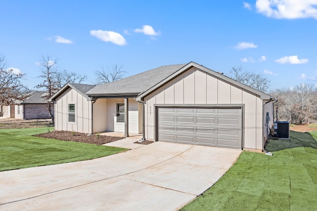 view of front facade featuring a garage, central AC, and a front yard