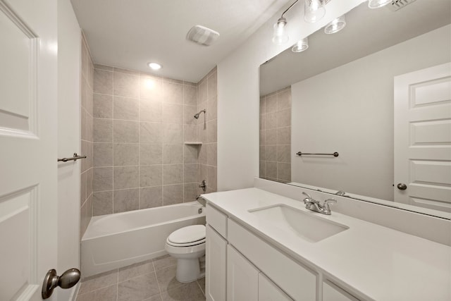 full bathroom with tile patterned flooring, vanity, tiled shower / bath combo, and toilet