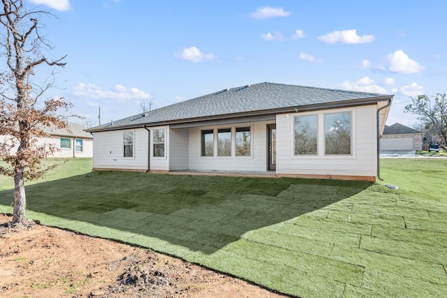 rear view of house featuring a yard