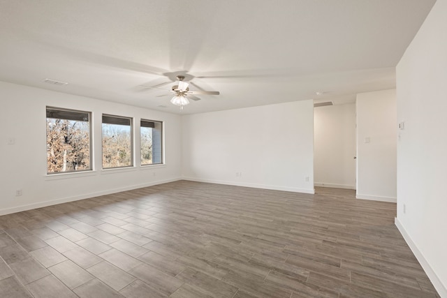 unfurnished room with hardwood / wood-style floors and ceiling fan