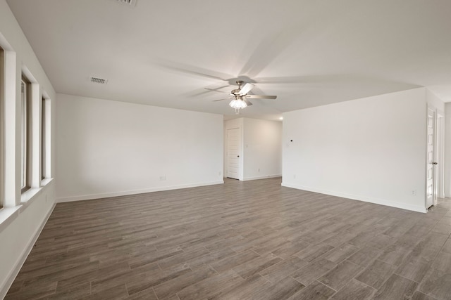 unfurnished room with dark wood-type flooring and ceiling fan