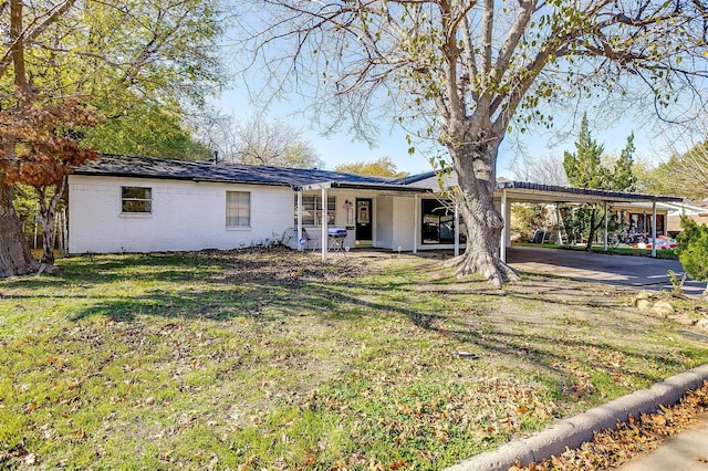 ranch-style home with a front yard and a carport