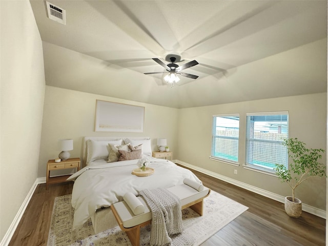 bedroom featuring ceiling fan, dark hardwood / wood-style flooring, and vaulted ceiling