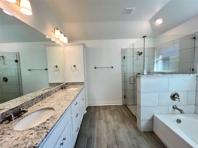 bathroom featuring vanity, plus walk in shower, and wood-type flooring