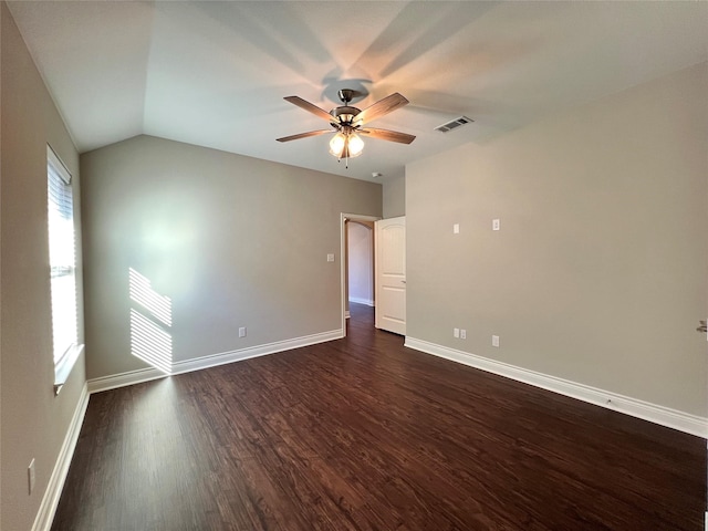 unfurnished room featuring dark hardwood / wood-style floors, ceiling fan, a wealth of natural light, and vaulted ceiling