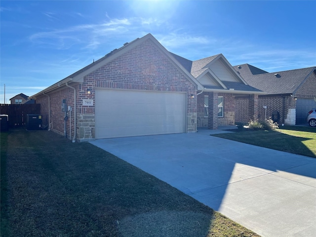 view of front of home with a garage and central AC