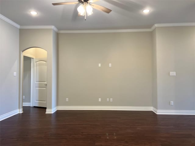 empty room with ceiling fan, ornamental molding, and dark wood-type flooring