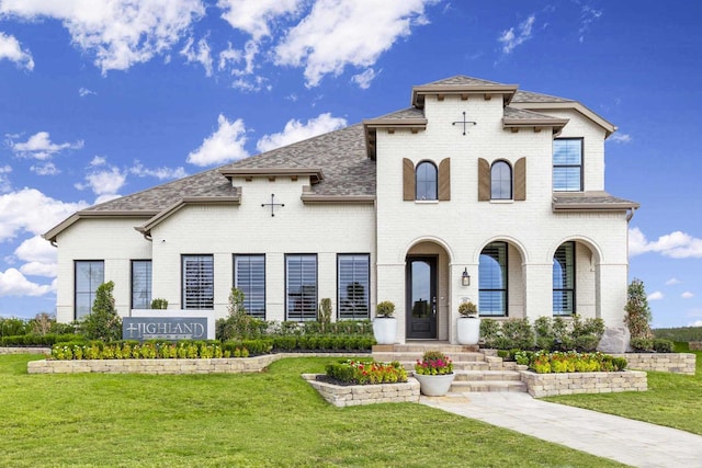 mediterranean / spanish-style house featuring a front lawn