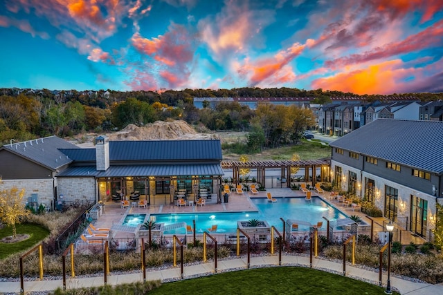 community pool featuring fence, a yard, and a patio area