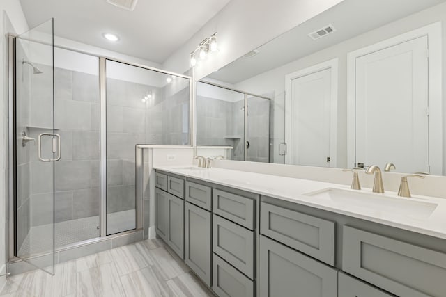 bathroom with vanity and a shower with shower door