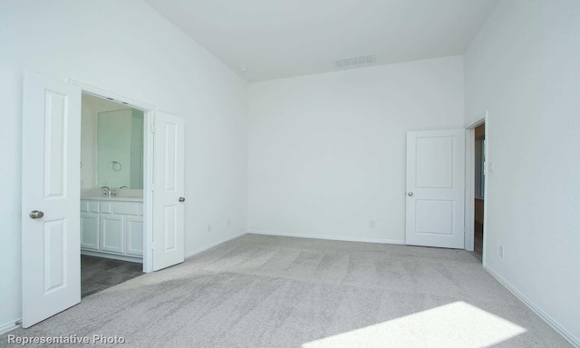 carpeted empty room featuring sink