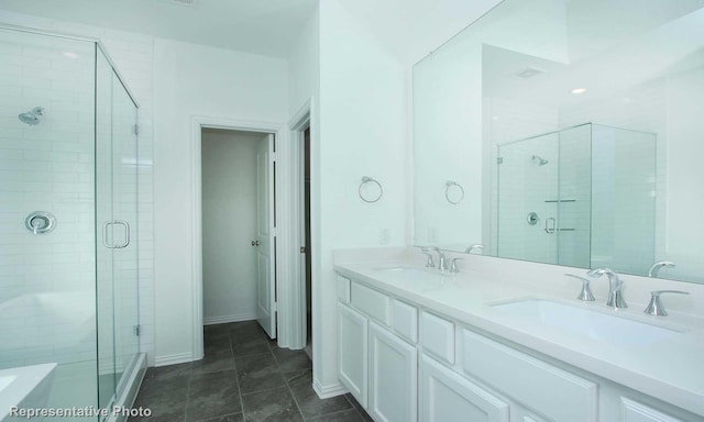 bathroom with vanity, an enclosed shower, and tile patterned floors