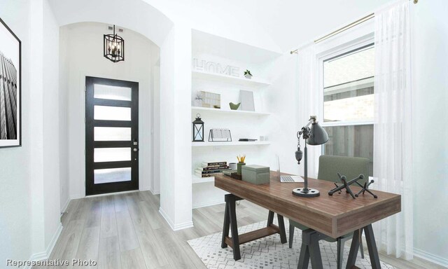 home office featuring an inviting chandelier and light hardwood / wood-style flooring