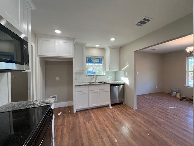 kitchen featuring dark hardwood / wood-style flooring, white cabinetry, and stainless steel appliances