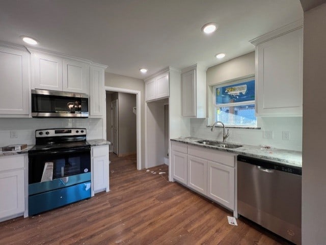 kitchen with white cabinetry, sink, and appliances with stainless steel finishes