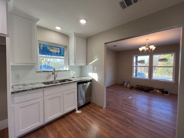 kitchen with dishwasher, white cabinetry, and sink