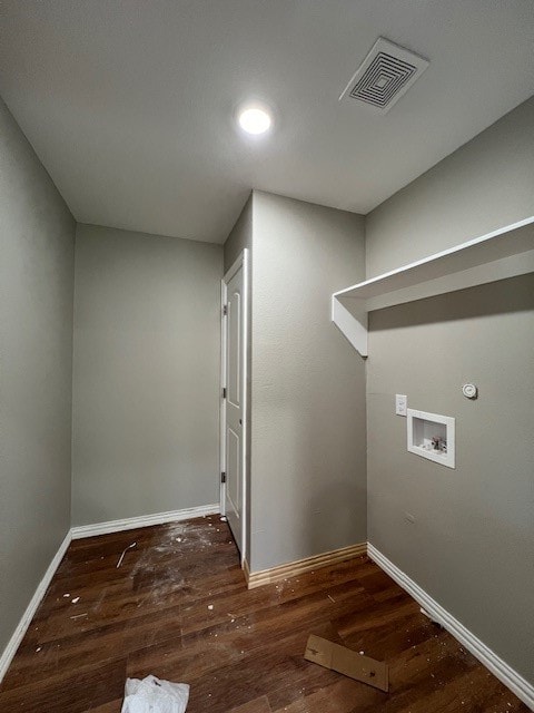 clothes washing area with dark hardwood / wood-style flooring and washer hookup