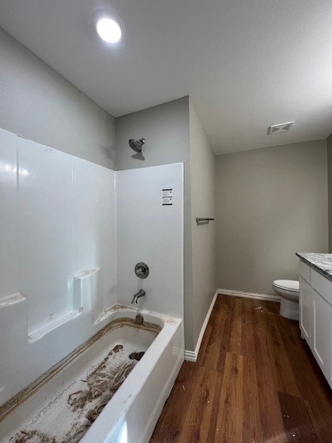 full bathroom featuring toilet, shower / washtub combination, vanity, and hardwood / wood-style flooring