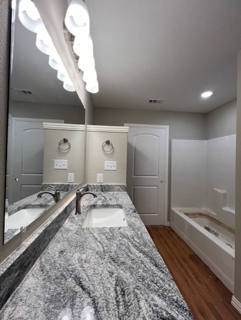 bathroom with vanity and wood-type flooring