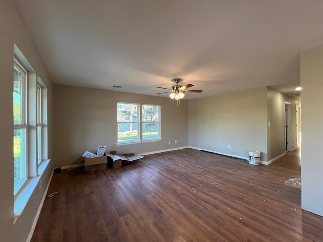 unfurnished room featuring ceiling fan and dark wood-type flooring