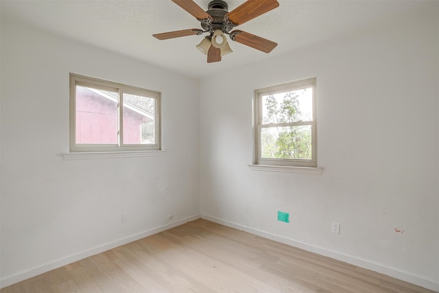 unfurnished room with ceiling fan, a healthy amount of sunlight, and light hardwood / wood-style flooring