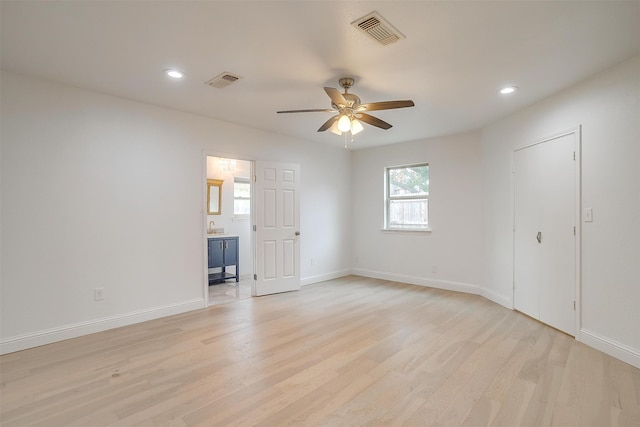 unfurnished bedroom with ceiling fan and light hardwood / wood-style floors