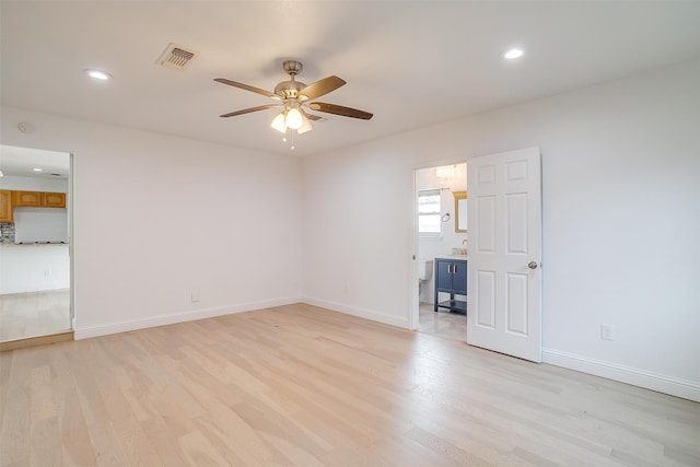 empty room with light hardwood / wood-style floors and ceiling fan