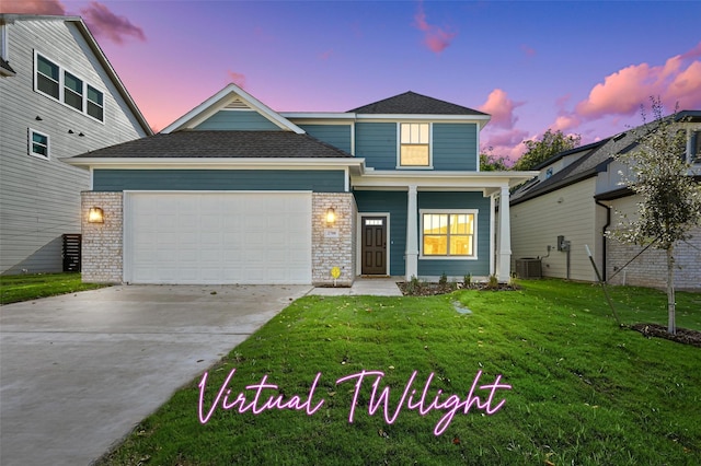 view of front of home with a yard, a garage, and central air condition unit