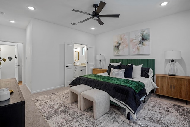 carpeted bedroom with ceiling fan and ensuite bathroom