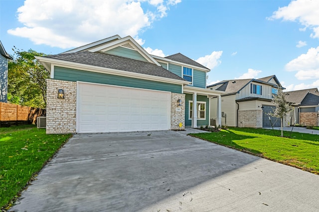 view of front of house featuring a front yard, a garage, and central AC unit