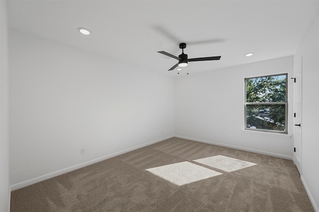 carpeted spare room with ceiling fan