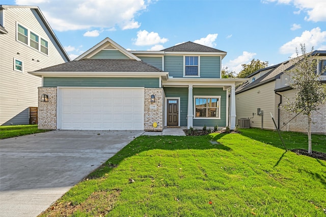 view of front of house with a garage, central AC unit, and a front yard