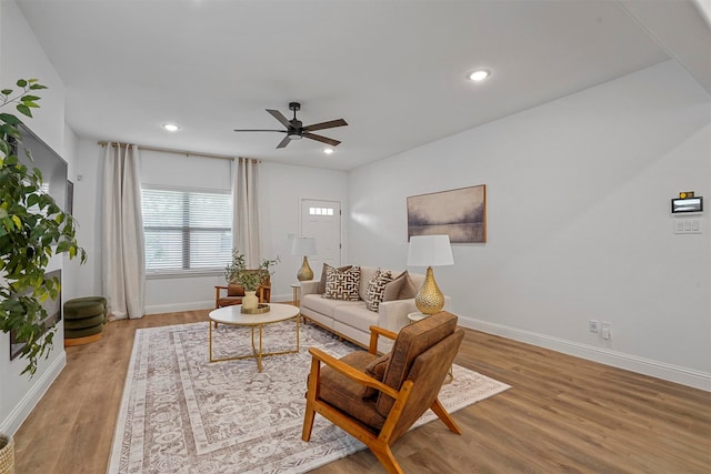 living room with hardwood / wood-style floors and ceiling fan