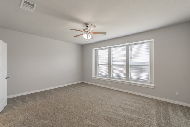 carpeted spare room with ceiling fan