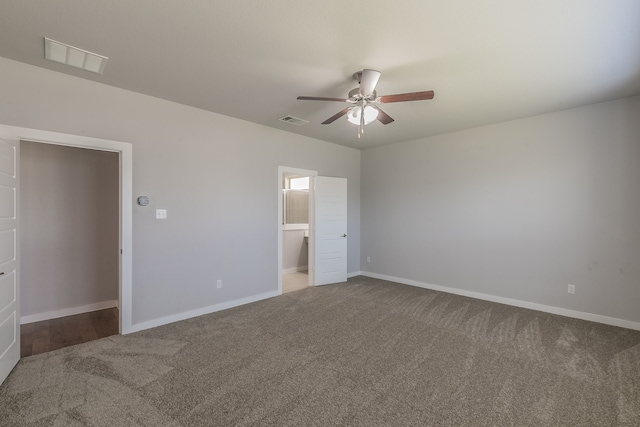 unfurnished bedroom with carpet floors, ensuite bathroom, and ceiling fan