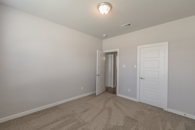 unfurnished bedroom featuring carpet flooring and a closet