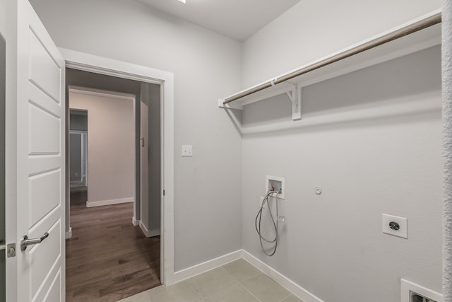 laundry area featuring washer hookup, hookup for a gas dryer, light hardwood / wood-style flooring, and electric dryer hookup