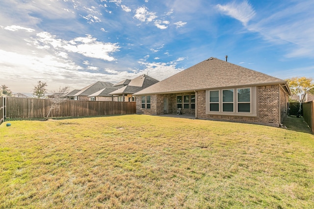 back of house with a lawn