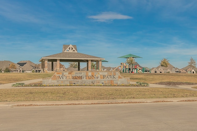 view of home's community featuring a playground and a yard