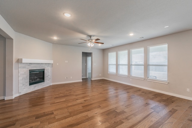 unfurnished living room with hardwood / wood-style floors, a textured ceiling, and ceiling fan