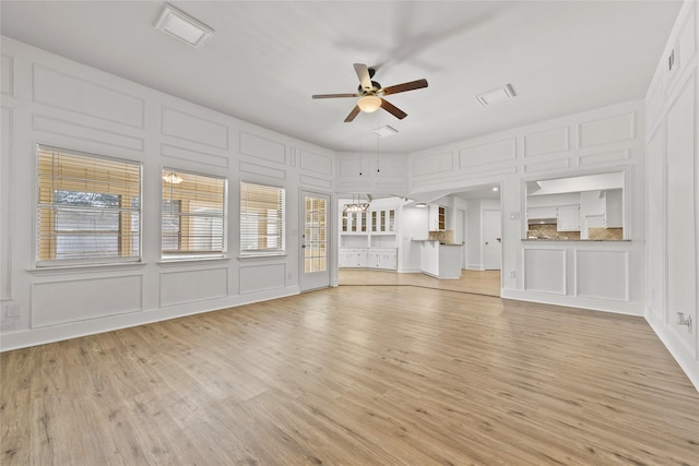 unfurnished living room featuring ceiling fan and light wood-type flooring