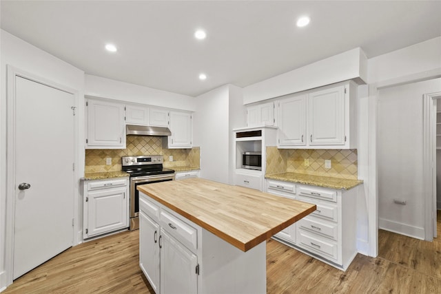 kitchen featuring white cabinetry, a center island, light hardwood / wood-style flooring, wooden counters, and appliances with stainless steel finishes