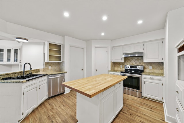 kitchen featuring appliances with stainless steel finishes, a center island, and white cabinetry