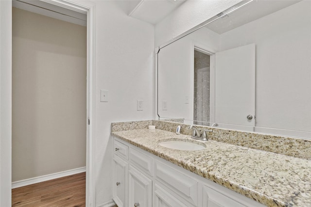 bathroom with hardwood / wood-style floors and vanity