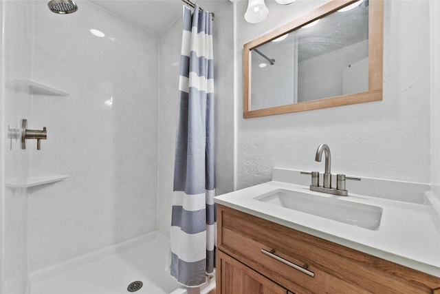 bathroom with curtained shower and vanity