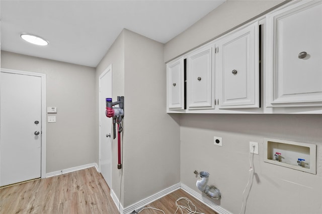 laundry room featuring hookup for a gas dryer, cabinets, light hardwood / wood-style floors, and washer hookup