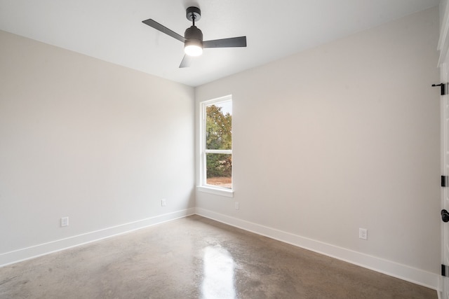 unfurnished room featuring ceiling fan and concrete floors