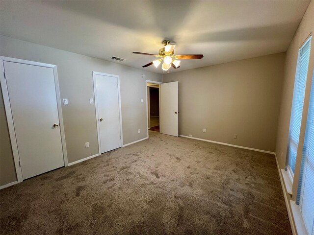 unfurnished bedroom featuring ceiling fan and carpet floors