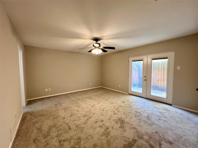 carpeted spare room with french doors and ceiling fan